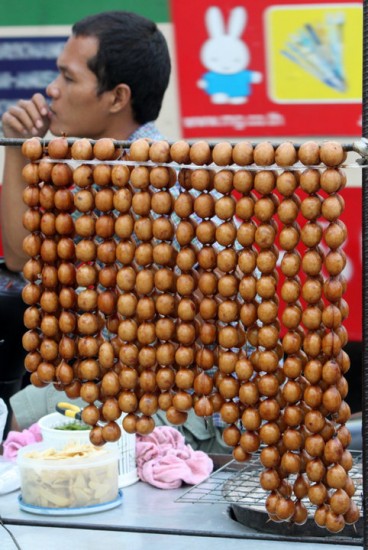 Thai Sausage Balls in Long Links on a Busy Bangkok Street