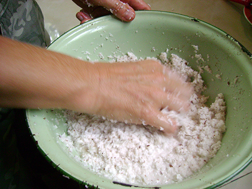 Massasging the coconut meat to extract the milk